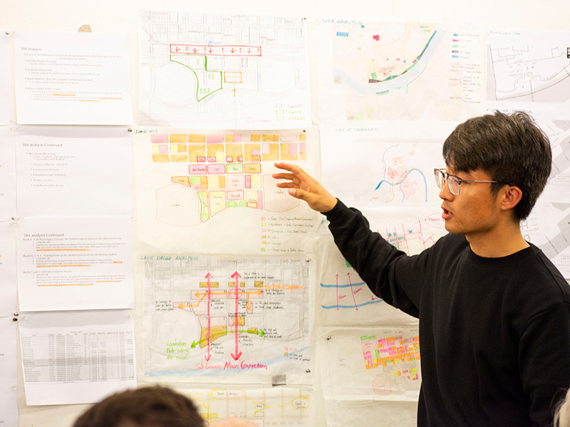 MSUD student presents drawings for his ULI Hines Design Competition project entry in the Hinman Research Building.