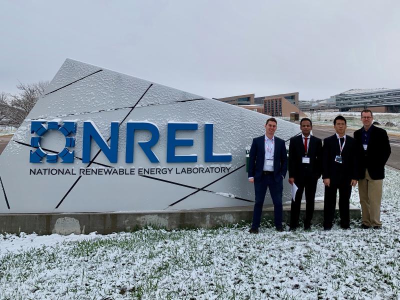 Student team from Georgia Tech standing in front of the NREL sign after the Department of Energy's Solar Decathalon in Colorado.