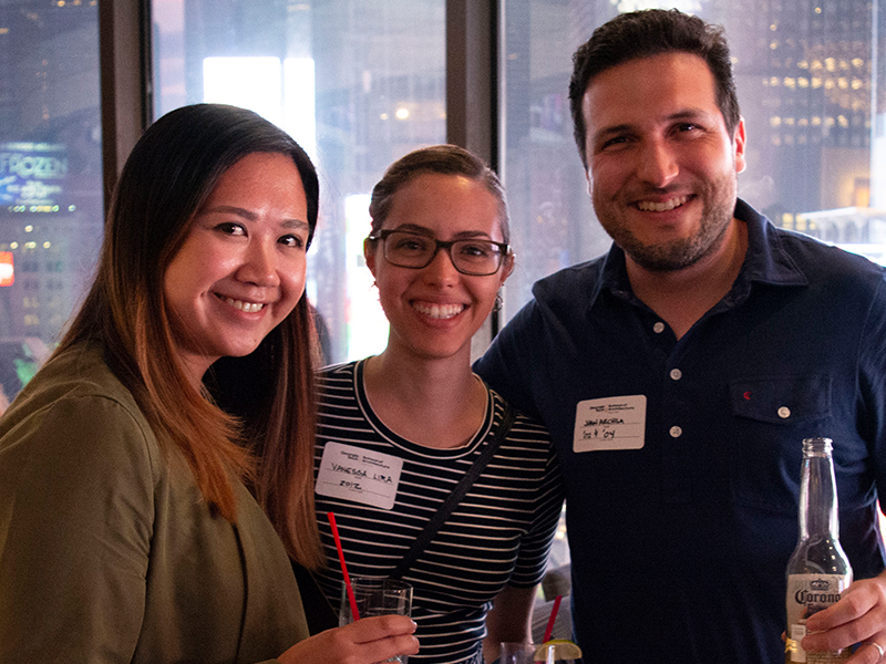 Three alumni pose together at the Marriott Marquis in Time Square at the Georgia Tech Alumni Reception at the 2018 AIA Conference in New York City.