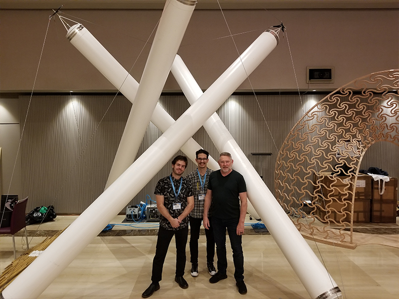 Michael Koliner, Jonathan Dessi-Olive, and Jim Case stand in front of an inflatable structure at the IASS Conference in Barcelona.