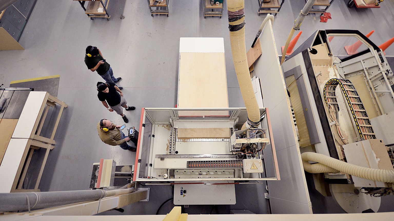 Overhead image of students the machinery available on the main level of the Digital Fabrication Lab