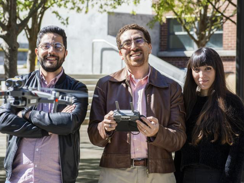 Yasser El Masri, Tarek Rakha, and Eleanna Panagoulia fly a drone in the Hinman Courtyard.