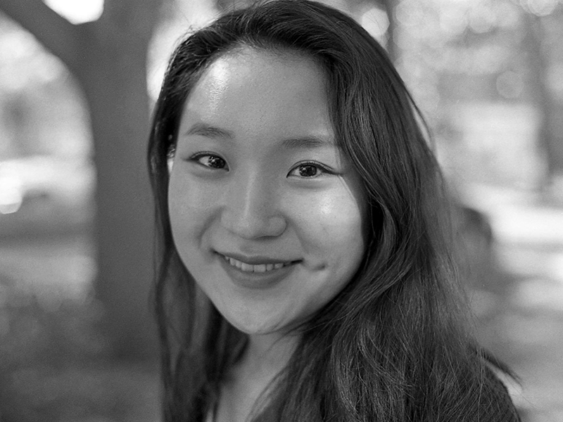 Minji Kim's profile photo outside in black and white.