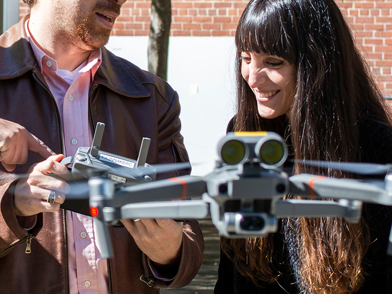 Ph.D. student and Tarek Rakha fly a drone in the Hinman Courtyard