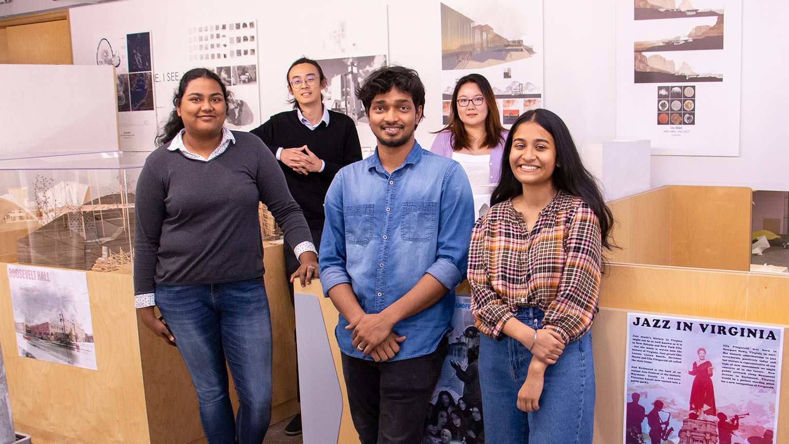 Group shot of five students in front of urban design posters
