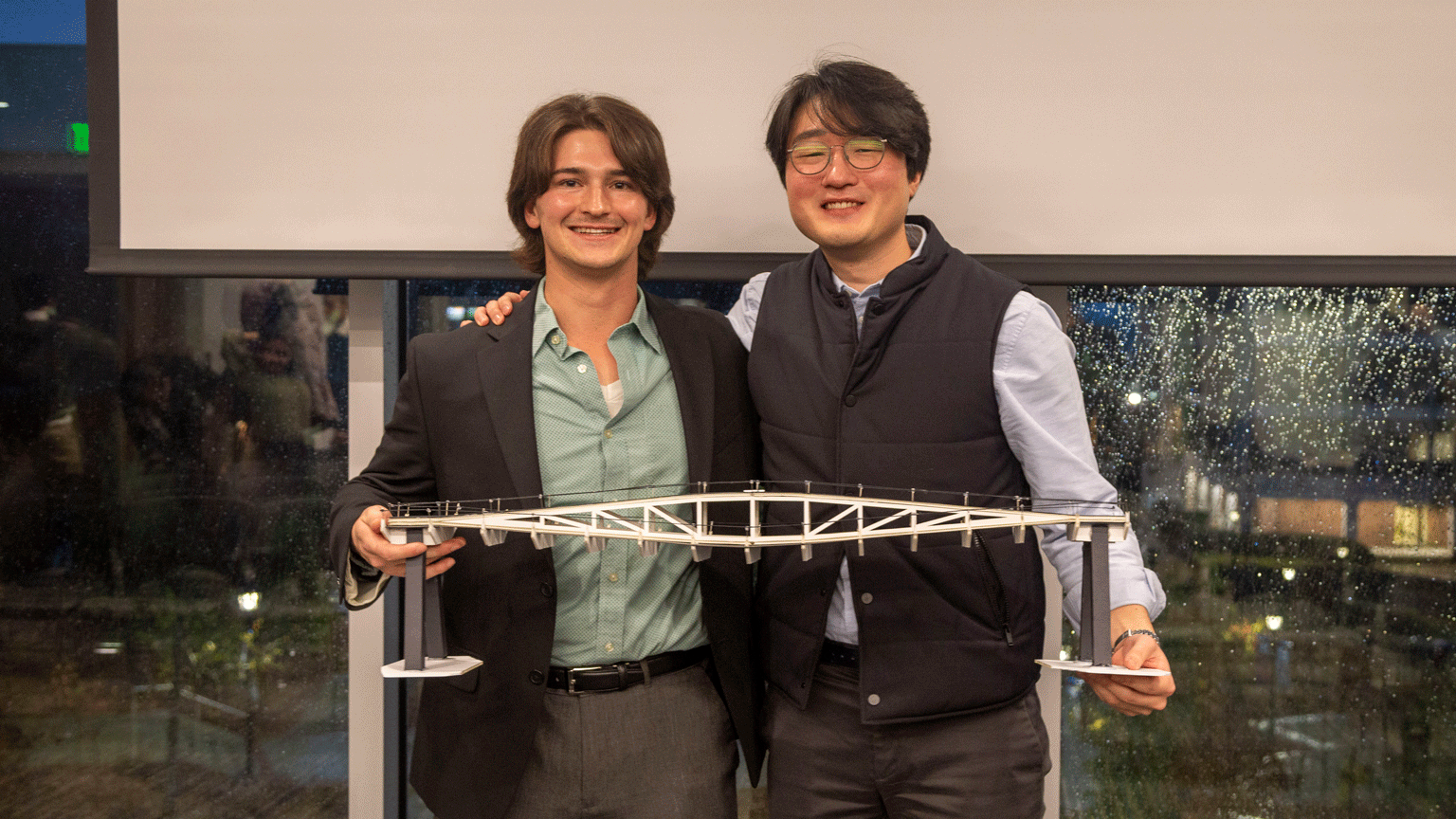 Isaac Wasson and Charles Kim pose with the model of their winning bridge design.