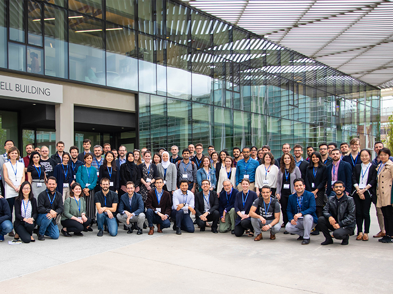 SimAUD Conference group photo in front of the John and Joyce Caddell Building.