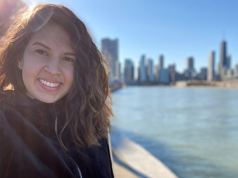 Rossana Franco Pinilla at Navy Pier with the Chicago skyline in the background.